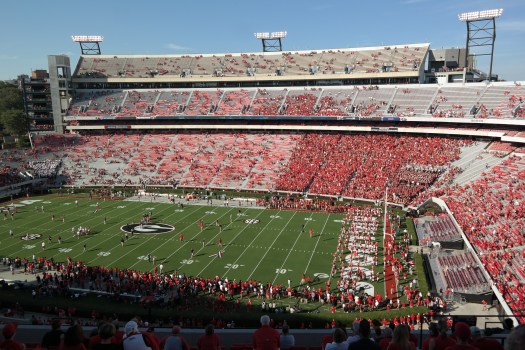 Mark Hocke, Director of Strength and Conditioning, leads warmups for the Dawgs